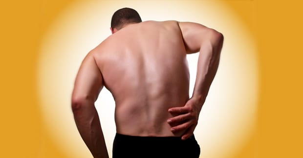Man holding his back because of Low Back Pain
