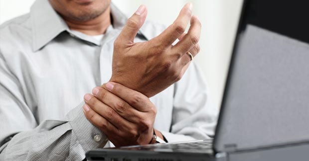 Man holding his wrist because of pain