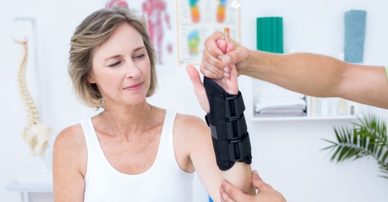 Doctor examining his patients wrist