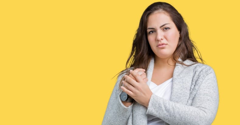 Beautiful plus size young woman wearing winter jacket over isolated