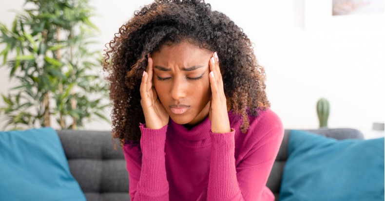 Young black woman suffering bad and strong headache