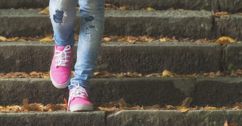 Detail of a womans shoes while walking down the stairs