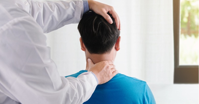Doctor physiotherapist doing neck adjustment stretching the injured