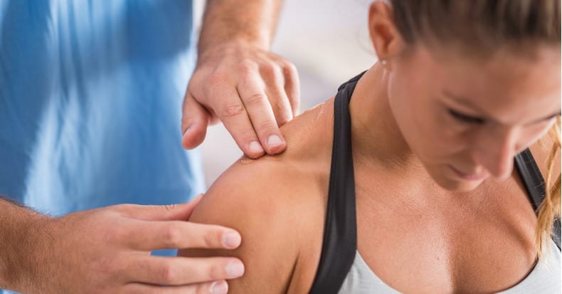 Physical therapy therapist addressing trapezius muscle