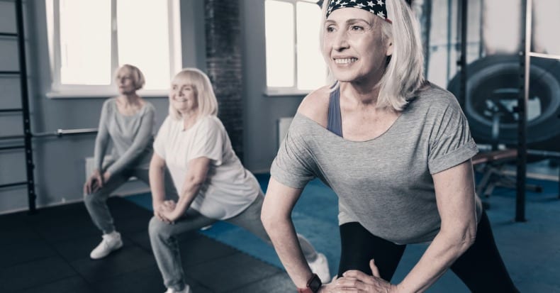 Three senior woman doing stretching together