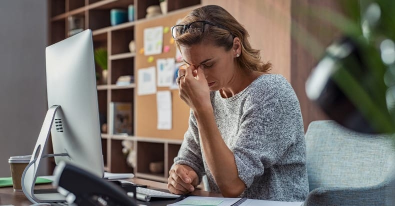 Business woman having headache at office