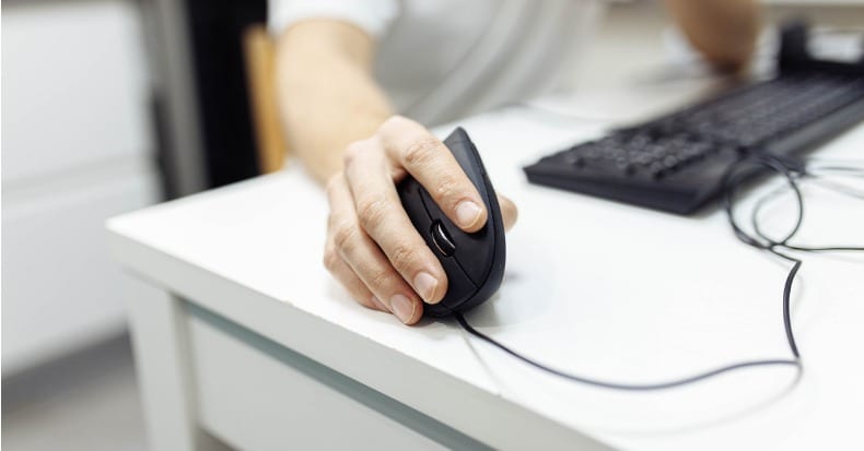 In the mans hand a vertical ergonomic computer mousejoystick is used