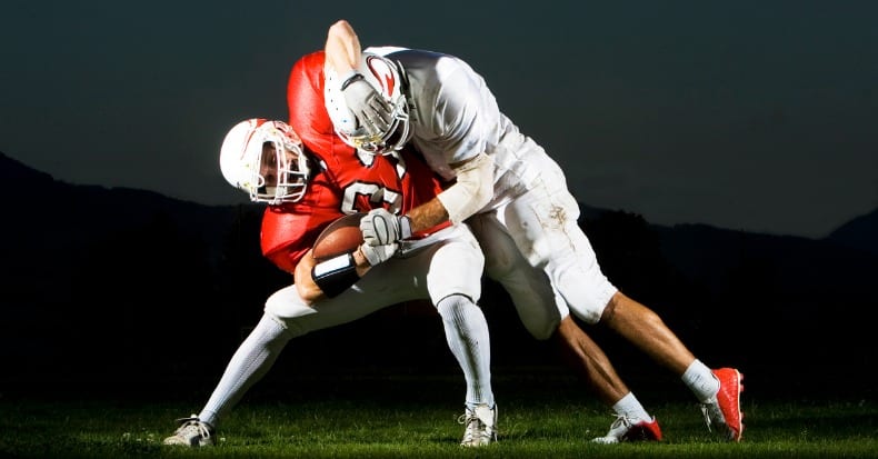 Two football players fighting for the ball