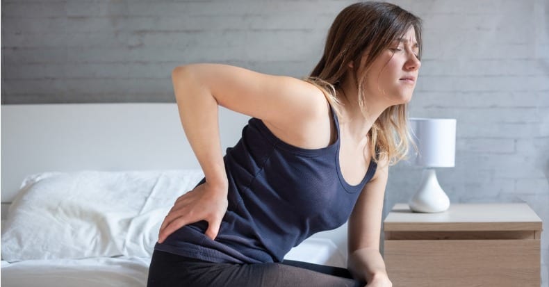 Woman waking up in the morning suffering backache