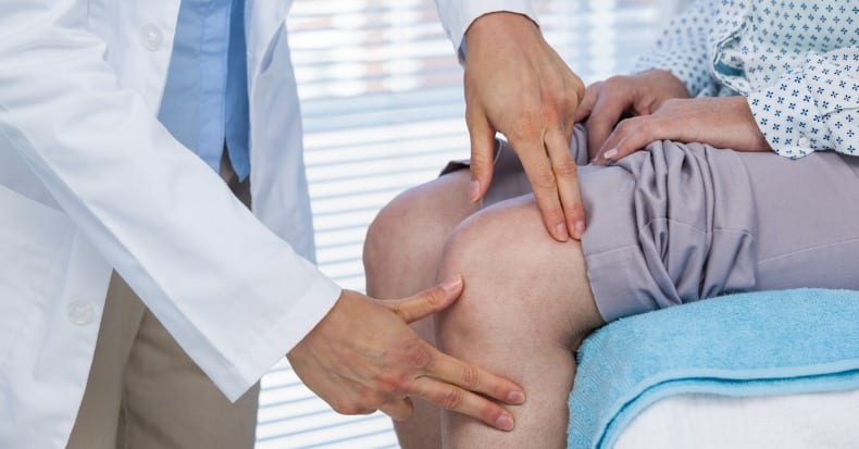 Doctor examining patient knee