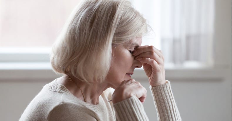 Fatigued upset older woman massaging nose bridge feeling eye strain