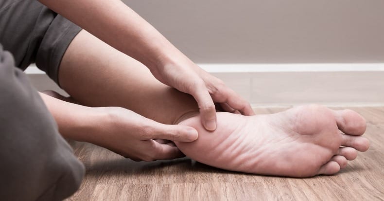 Female foot heel pain plantar fasciitis