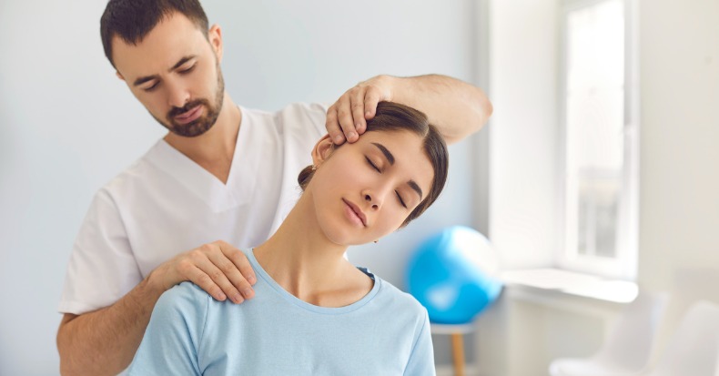 Licensed chiropractor doing neck adjustment to female patient