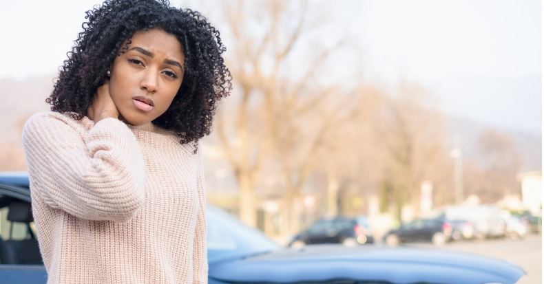 Portrait of painful young black woman after car crash